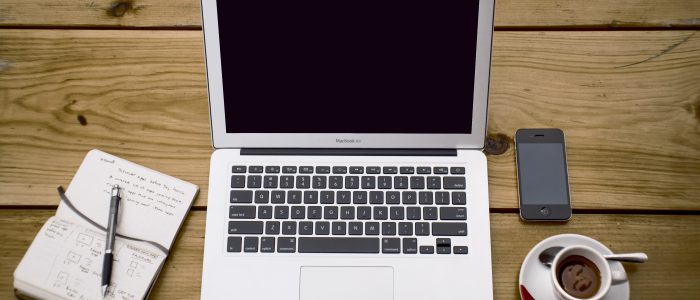 Laptop on desk with other essentials for work set up a like a home office