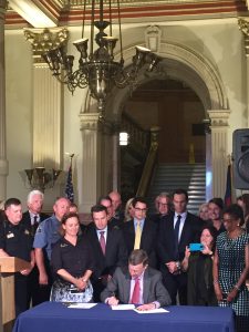 Governor Hickenlooper signs HB-1220 and HB-1221 into law with Majority Leader, K.C. Becker, and representatives from a diverse range of stakeholders who support limiting marijuana plant counts and diversion to the illegal market including Janene Johnson who represented the Colorado Association of REALTORS®.