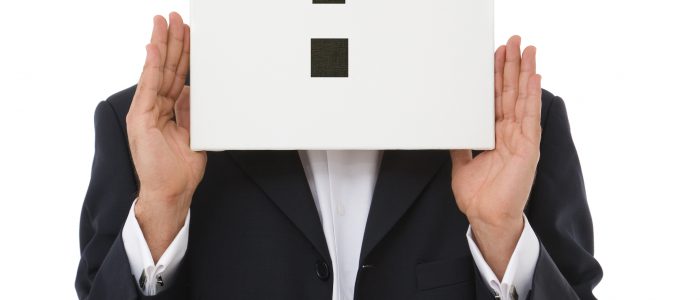 businessman holding a question mark on white background