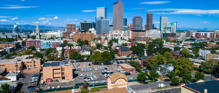 Denver , Colorado Skyline Rises in the Middle of entire City view from historic buildings , to modern , to the State capitol building , all the way to the Rocky Mountains on a perfect summer sunny morning 2018 aerial drone view