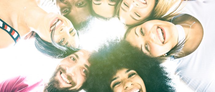 Multicultural best friends millenials taking selfie with back lighting - Happy youth friendship concept against racism with international young people having shared fun together - Vivid azure filter