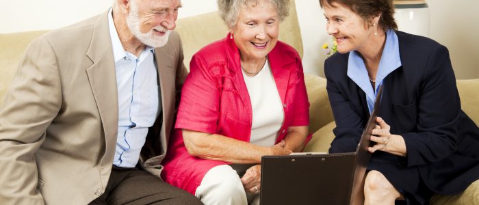 Saleswoman meets with senior couple in their home. Could be real estate life insurance etc.